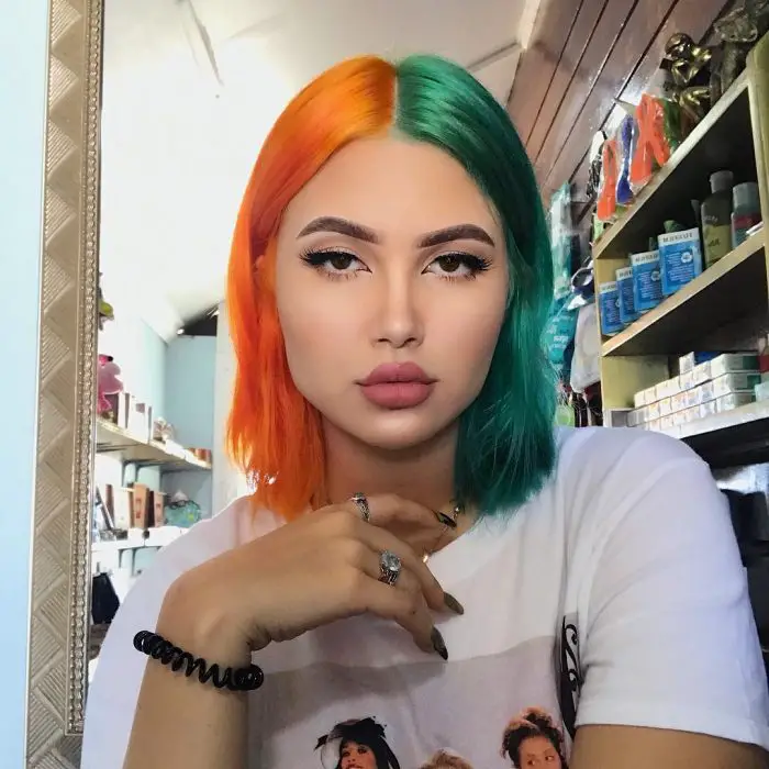 Menina com cabelos de cores diferentes, laranja e verde