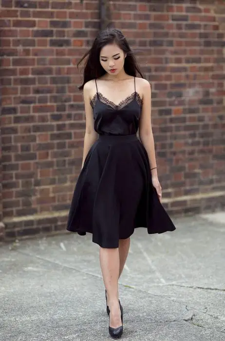 Mulher de cabelo preto liso em vestido de seda preta