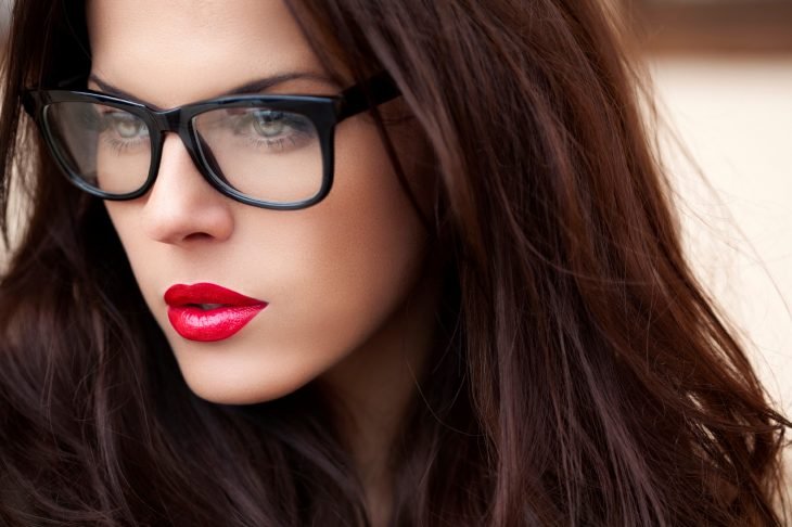 mulher com óculos e lábios vermelhos