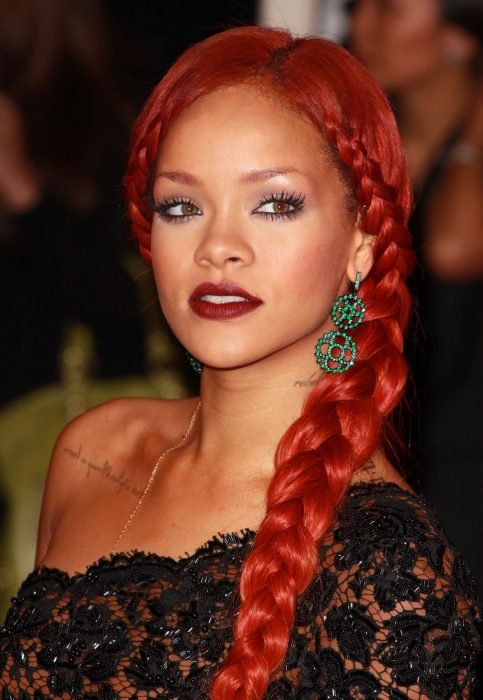 Rihanna ostentando uma trança lateral que destaca seu decote. 