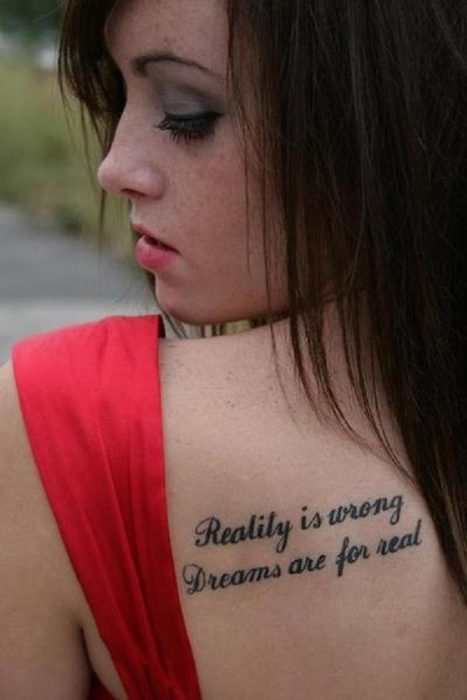 Menina vestida de vermelho com uma frase tatuagem nas costas 