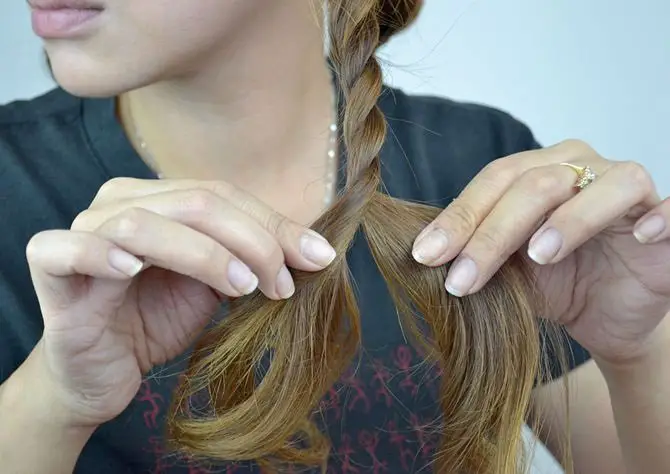 menina separa o cabelo em seções
