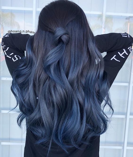 Garota por trás mostrando seus longos cabelos azuis 