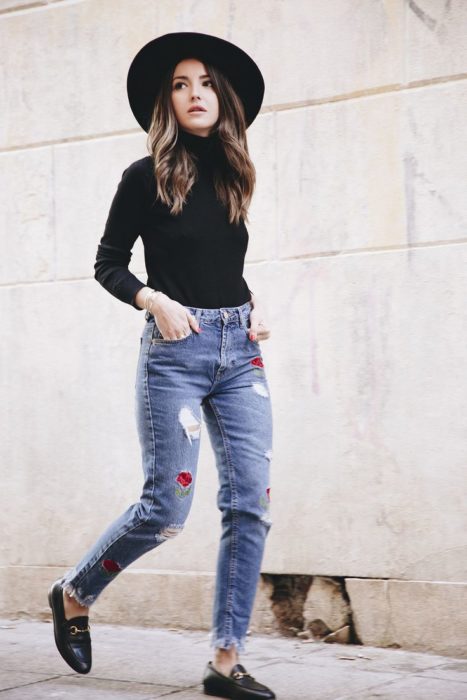 Garota usando mocassins com jeans rasgados e blusa preta 