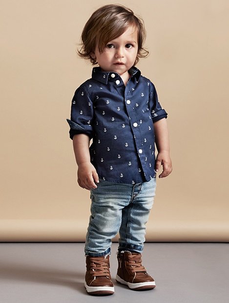 Criança mini fashionista vestida casual com botas 